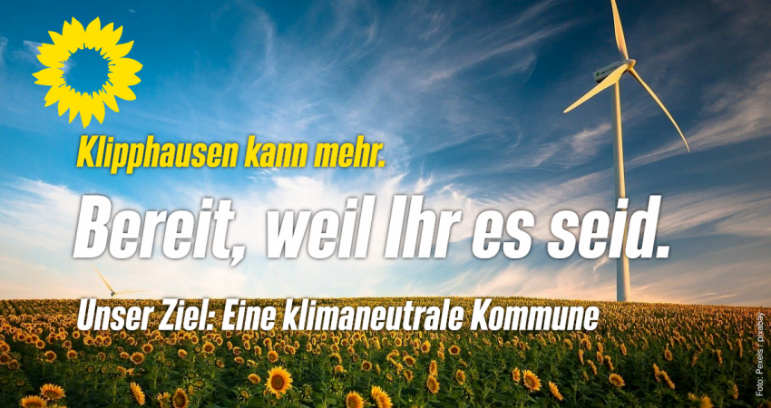 Ein Windrad in einem Sonnenblumenfeld. Text: Klipphausen kann mehr. Bereit, weil Ihr es seid. Unser Ziel: eine klimaneutrale Kommune